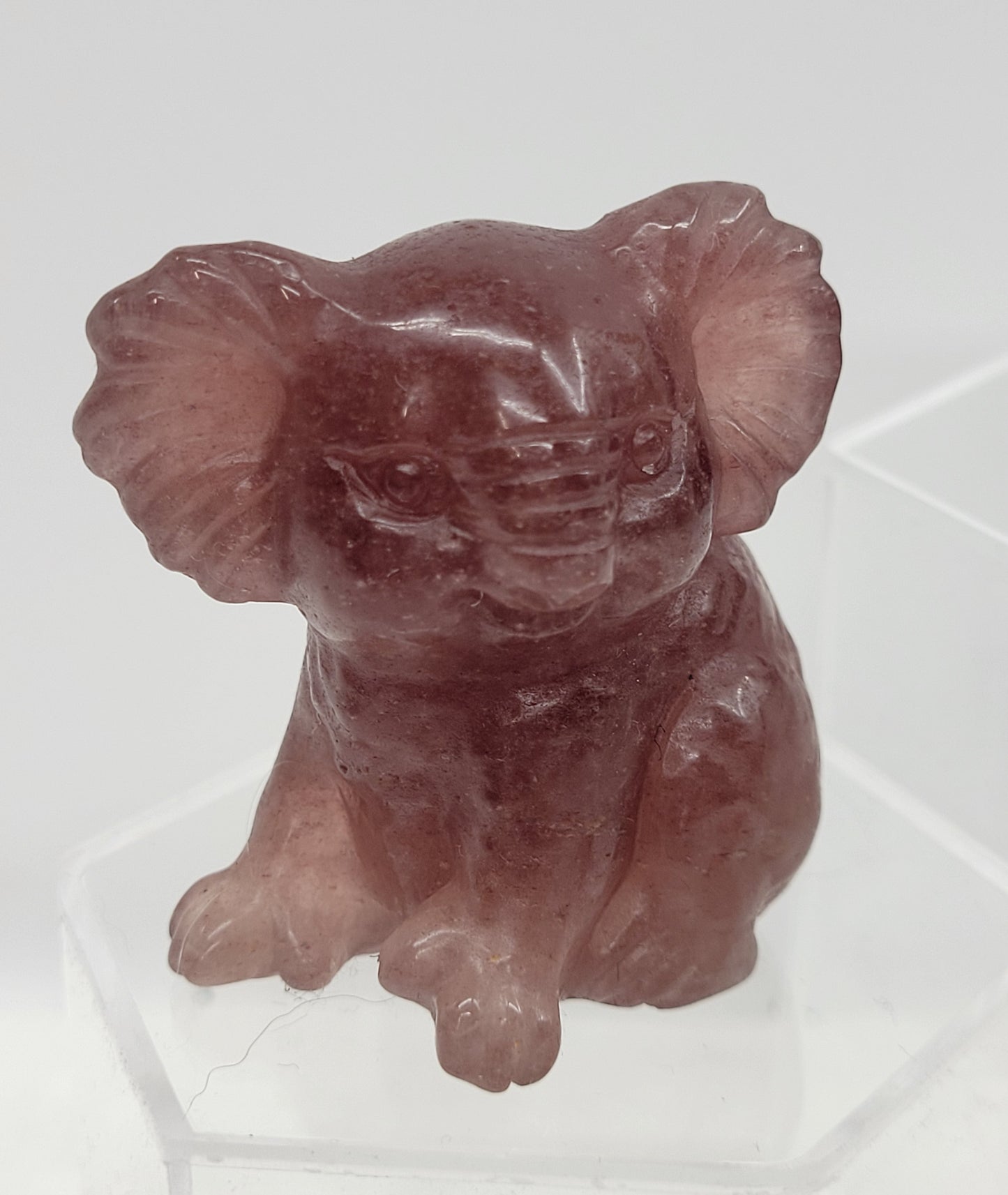Strawberry Quartz Koala carving on a white background