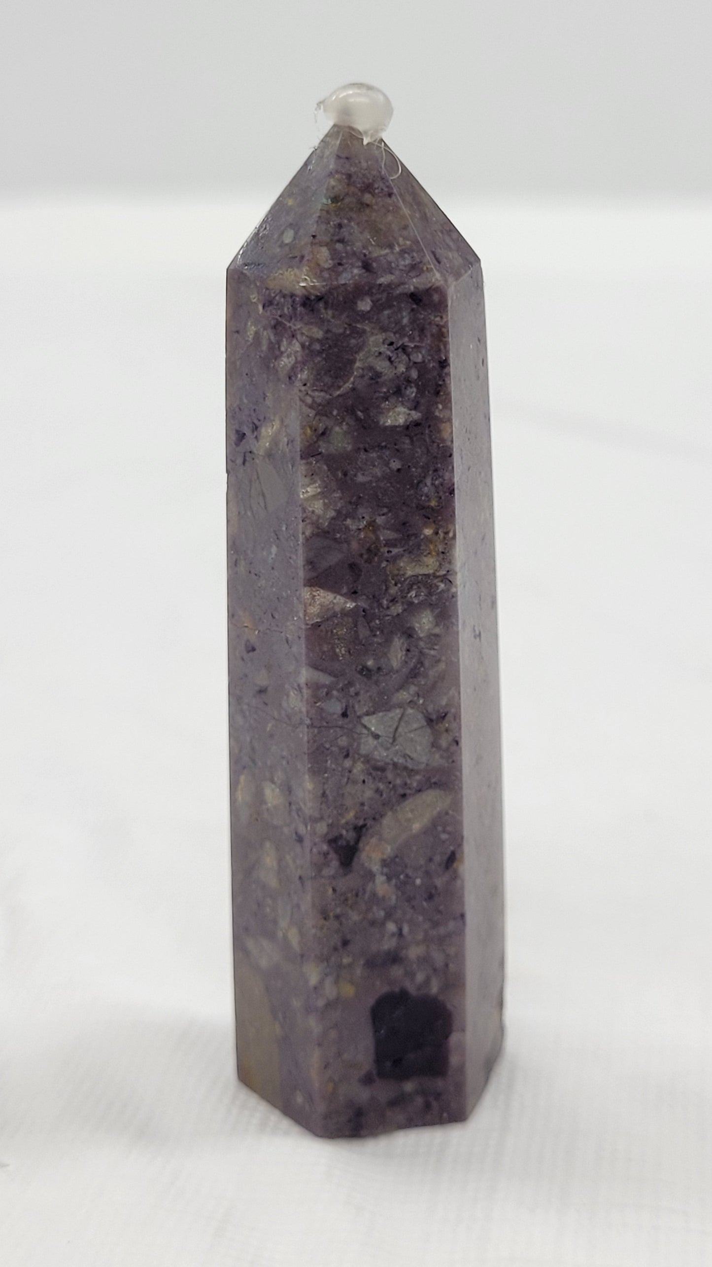 Brecciated Fluorite tower against a white background