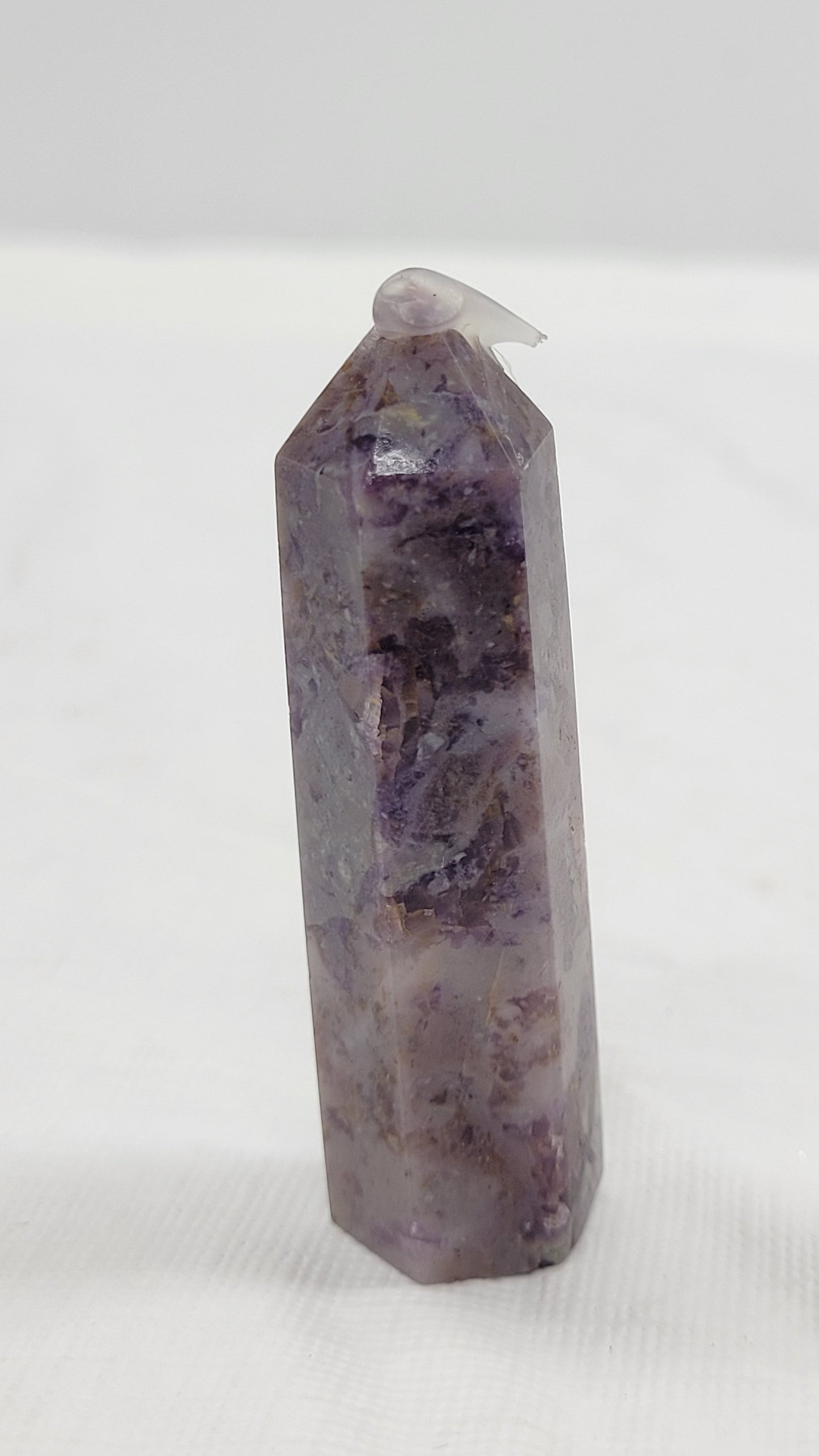 Brecciated Fluorite tower against a white background