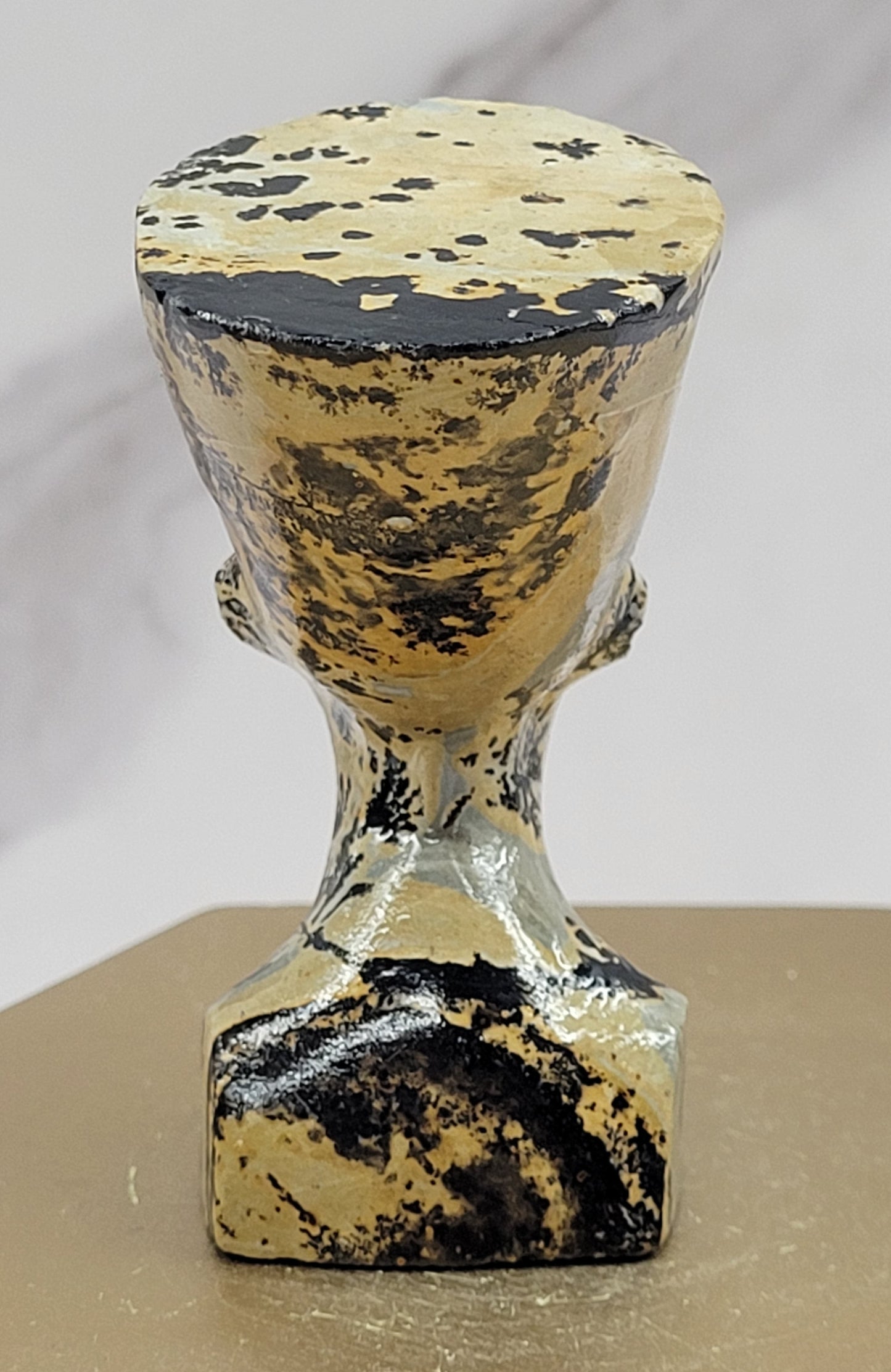 A Queen Nefertiti carving made from Picture Jasper, displaying the distinctive stone patterns against a neutral background.