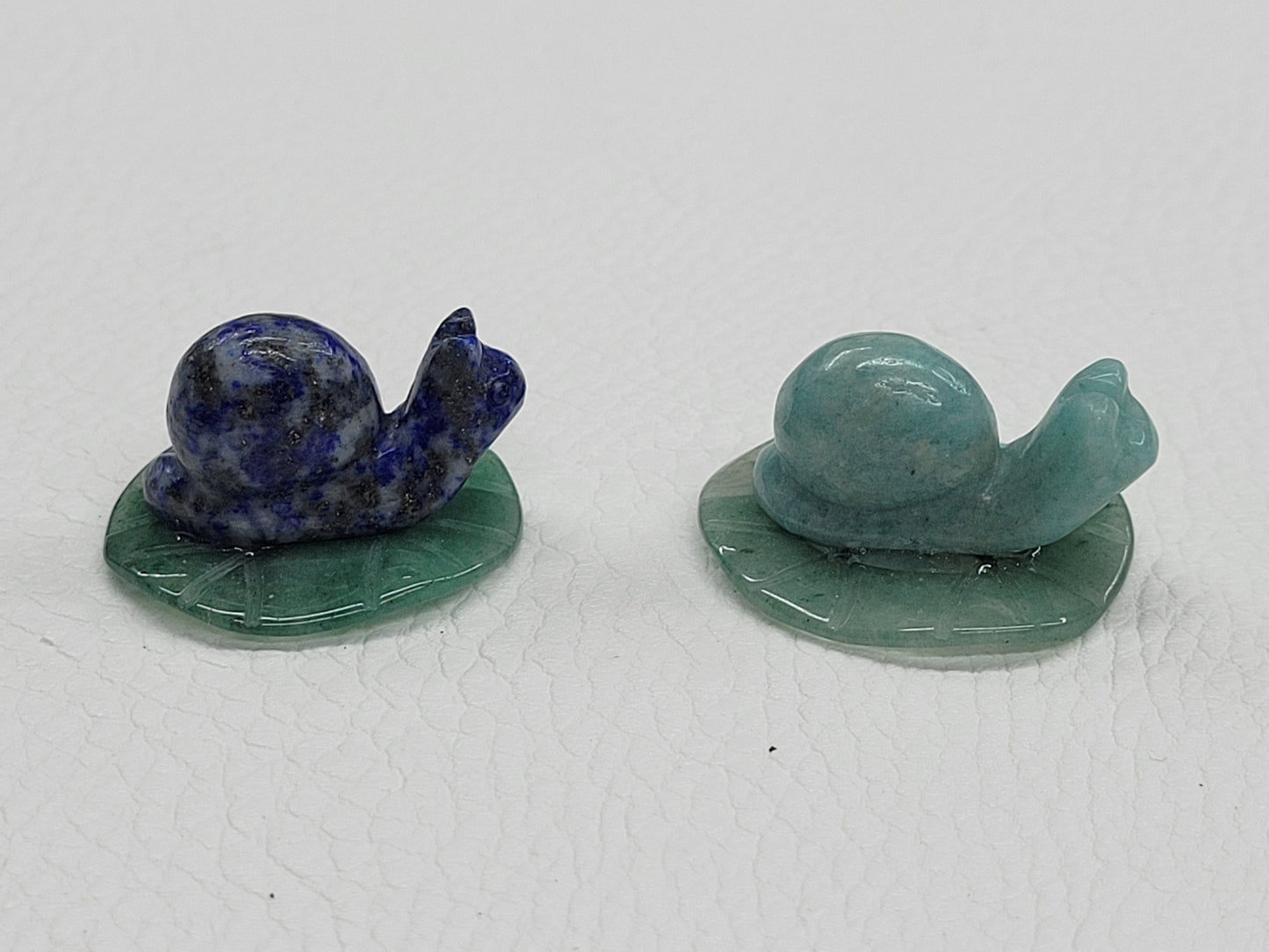 Snail on lily pad carving