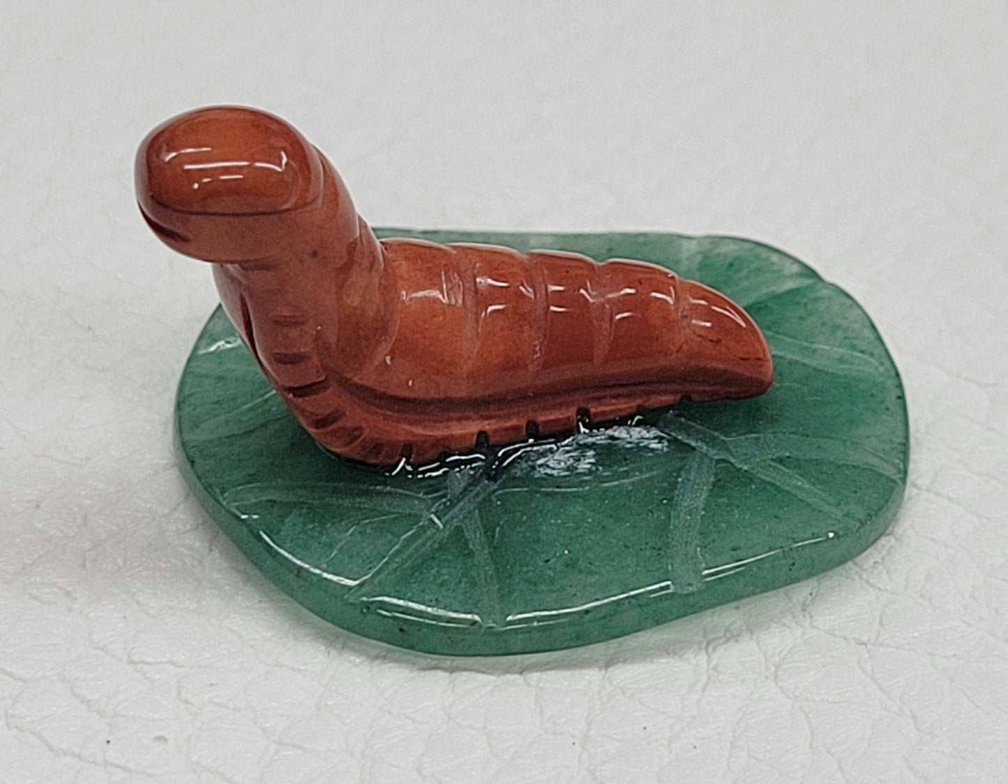Caterpillar on leaf/lily pad carvings