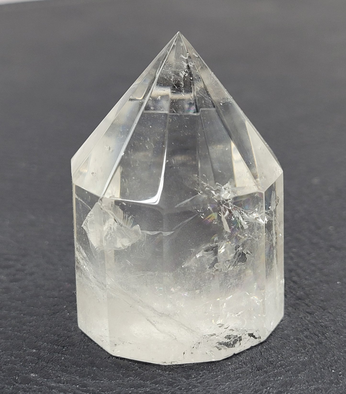 Clear crystal point on a dark surface