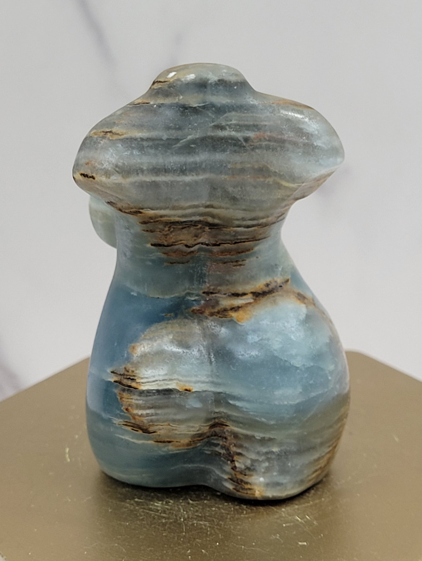Blue Onyx woman body carving with tan banding