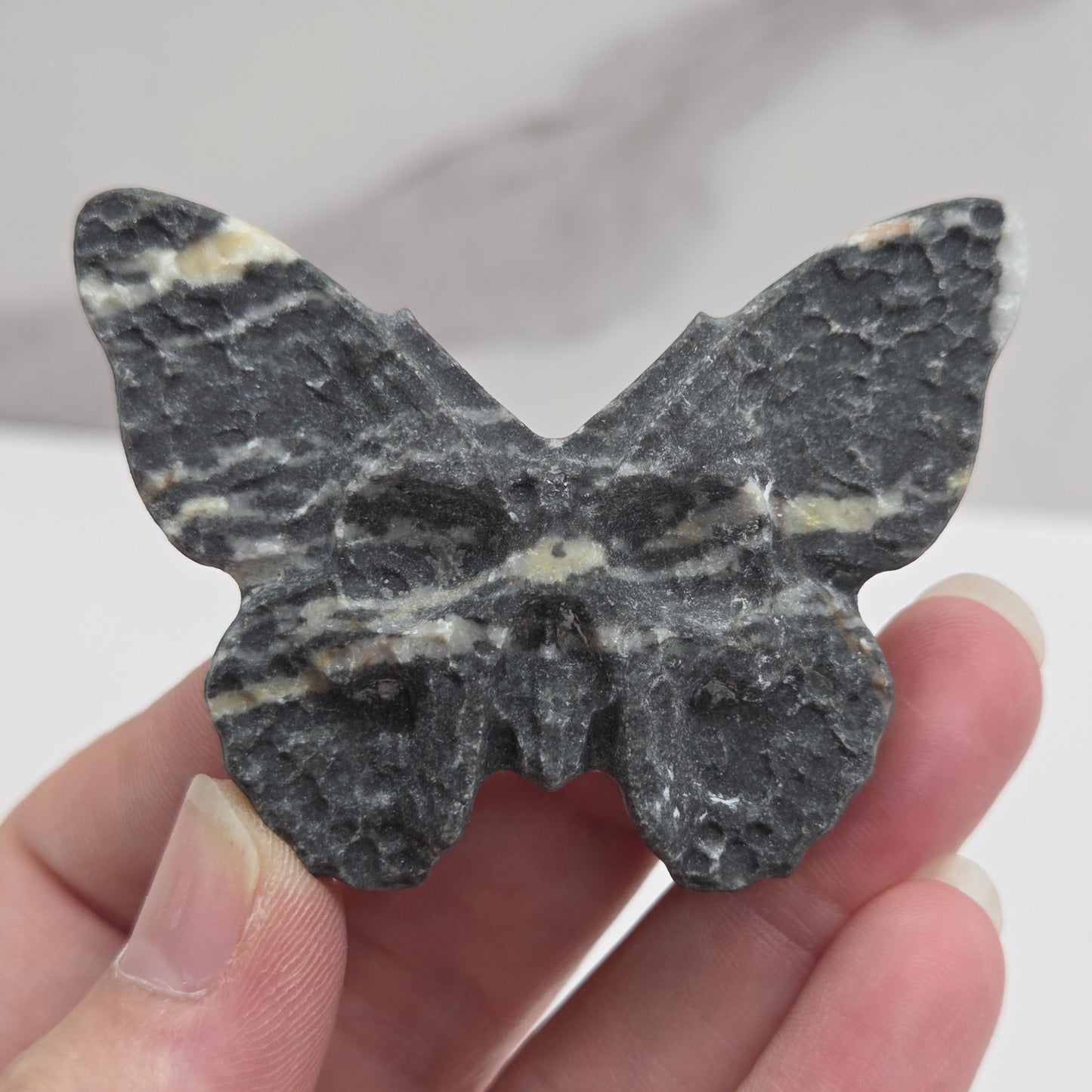 Skull moth carving