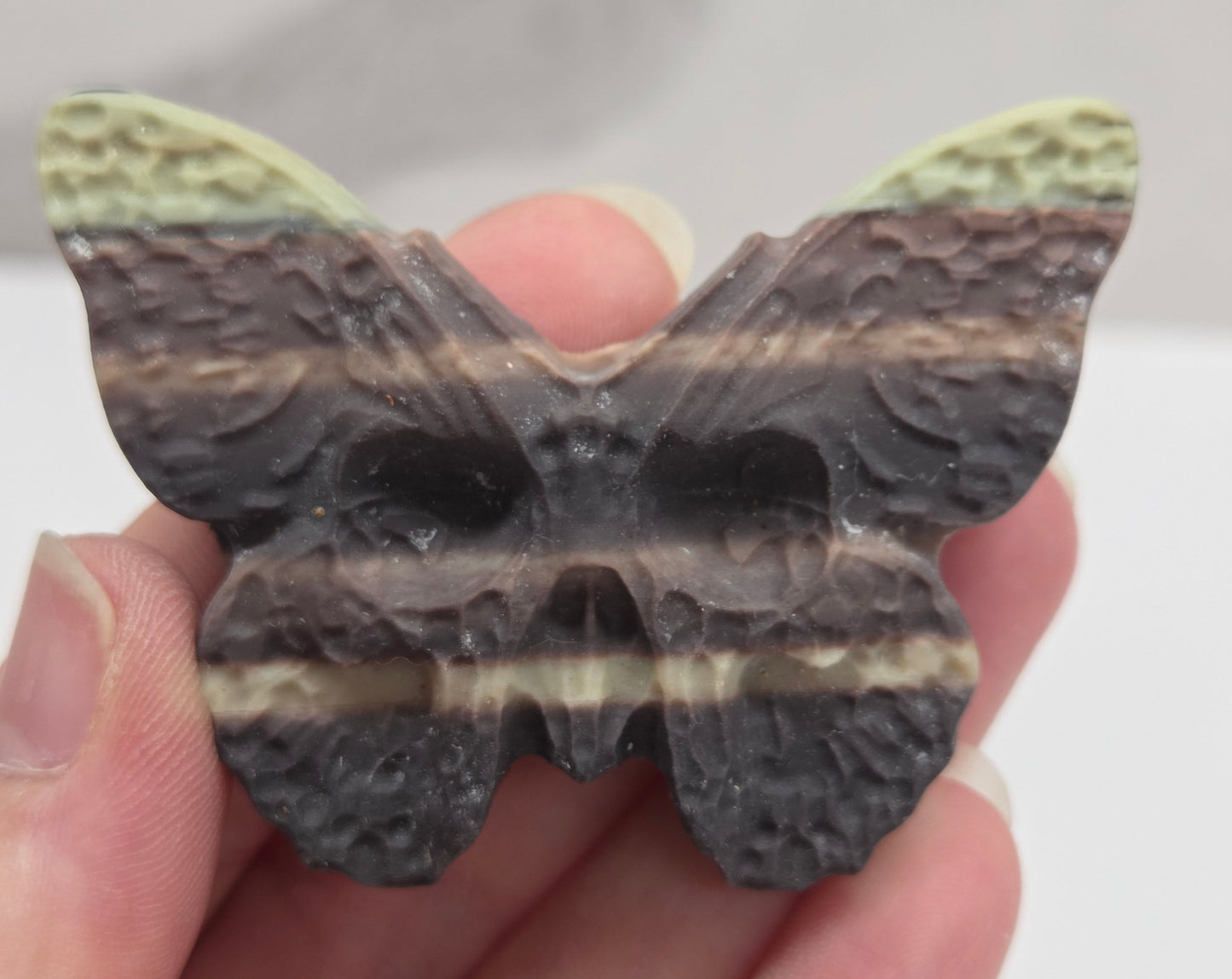 Skull moth carving