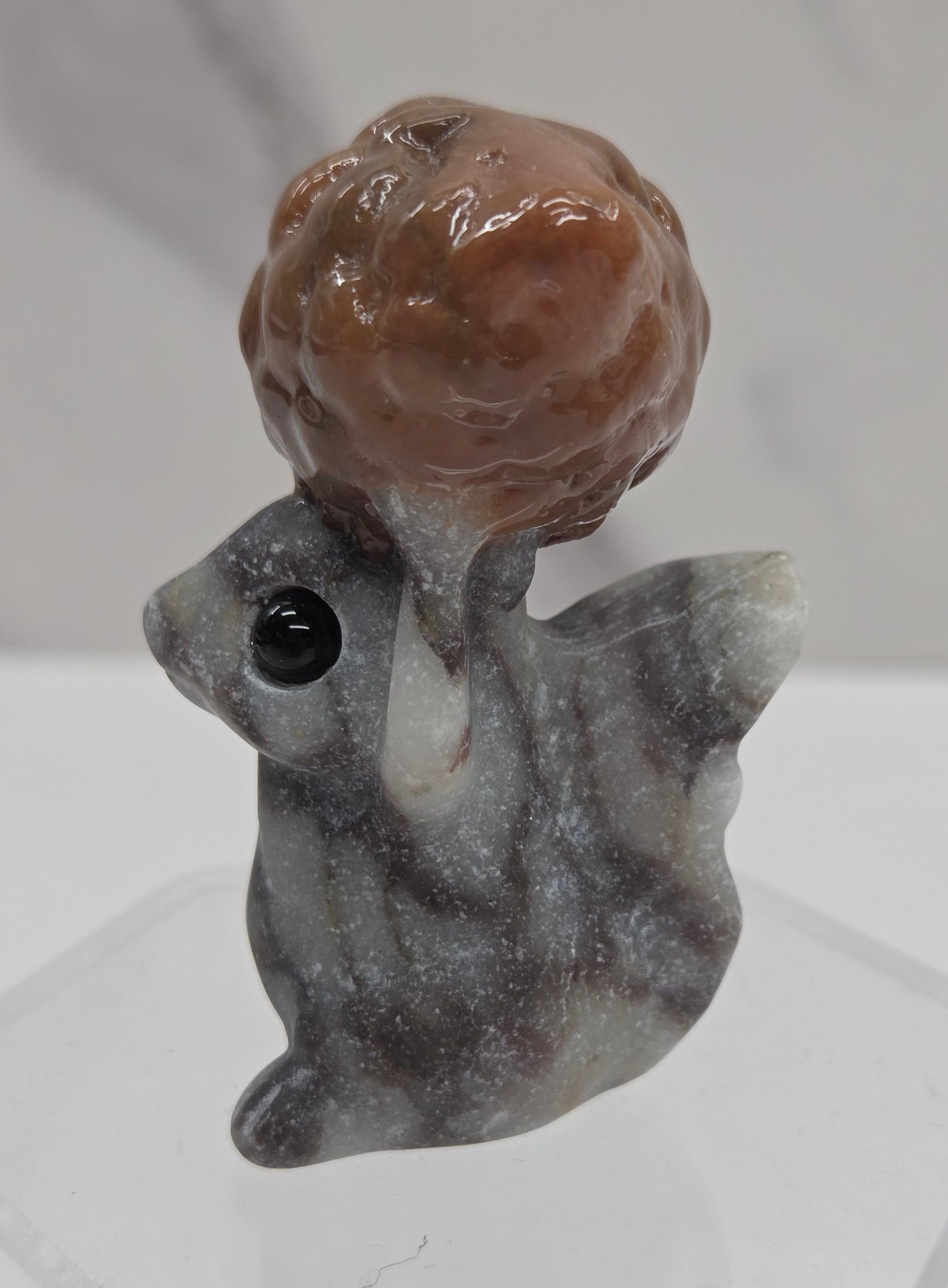 Squirrel holding nut carving