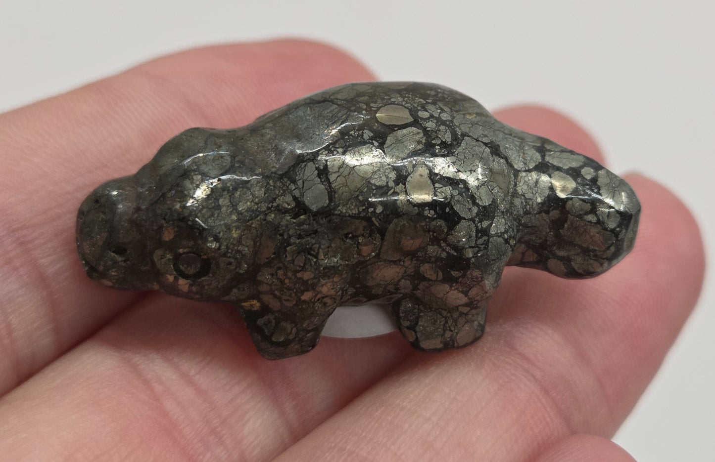 Pyrite platypus carving on a white background