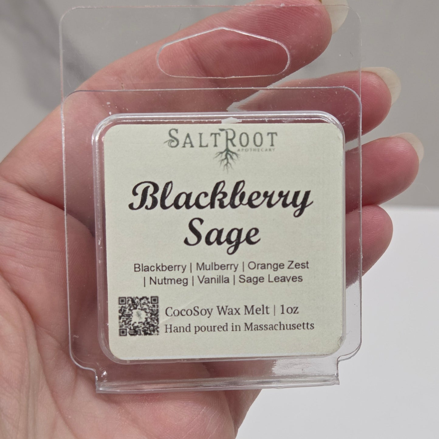 Hand holding a wax melt package labeled 'Blackberry Sage' by Salt Root.