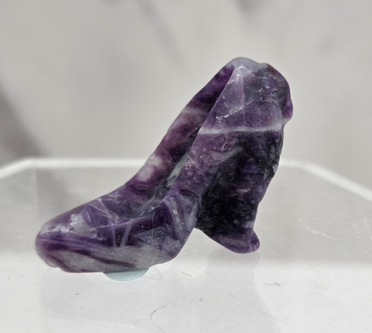 Fluorite Root high heel crystal carving against a grey background