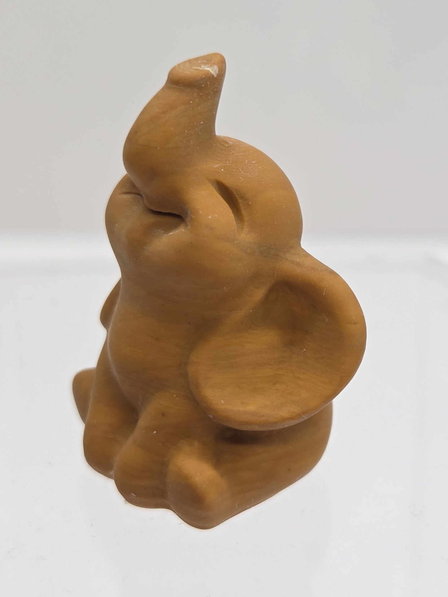 Brown Jasper elephant carving on a white background