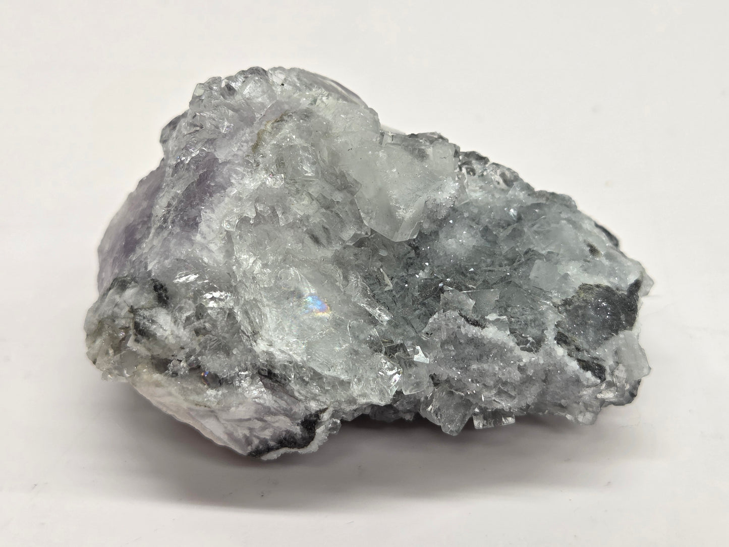 Purple Fluorite specimen against a white background