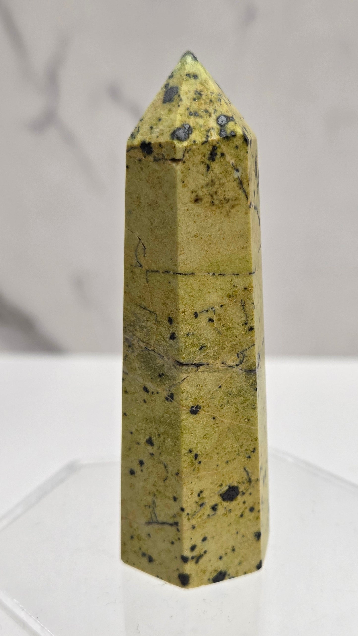 Carved Septarian tower with greenish yellow color and black dots