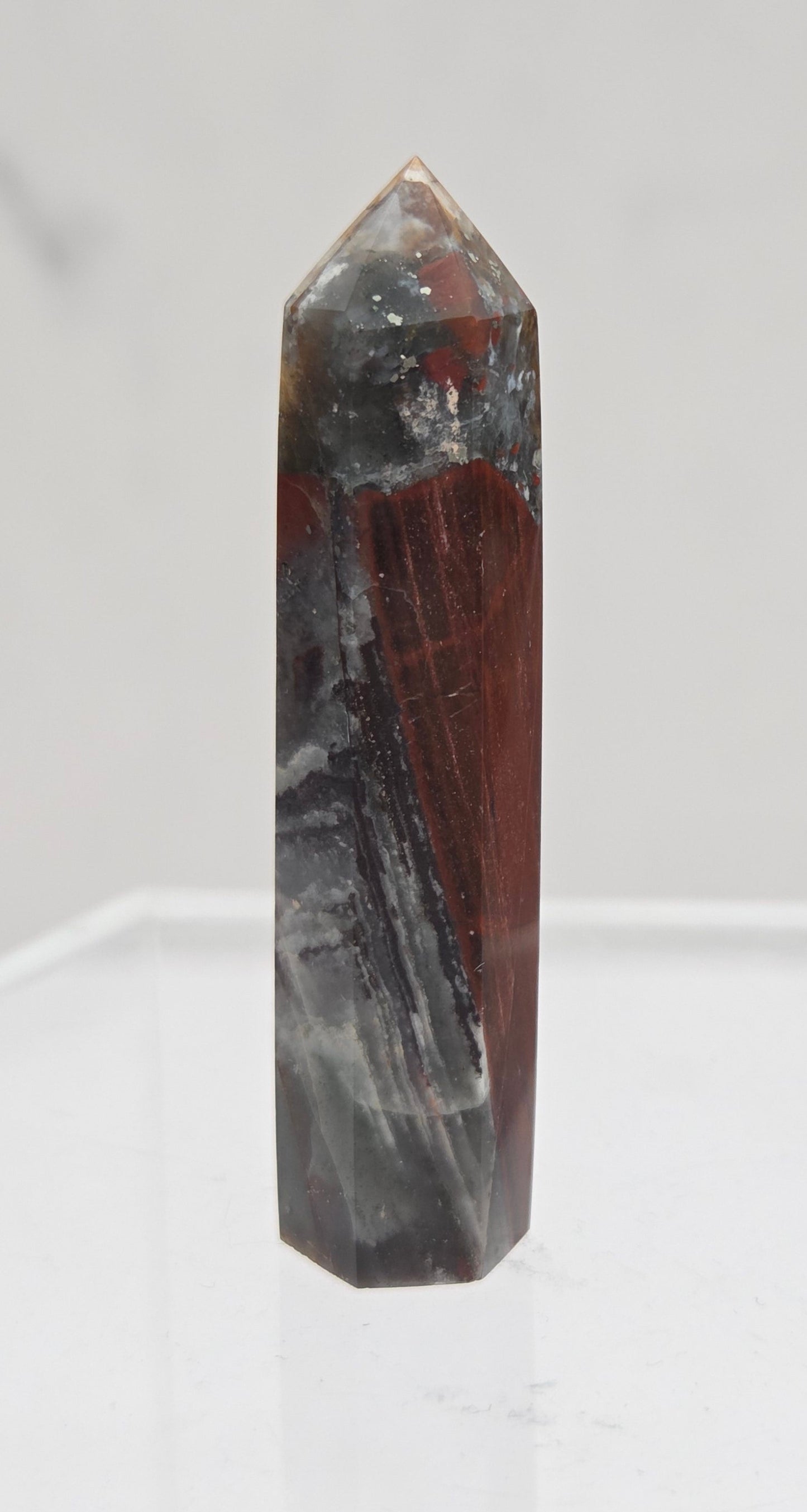 African Bloodstone crystal tower with red and black patterns on a white background