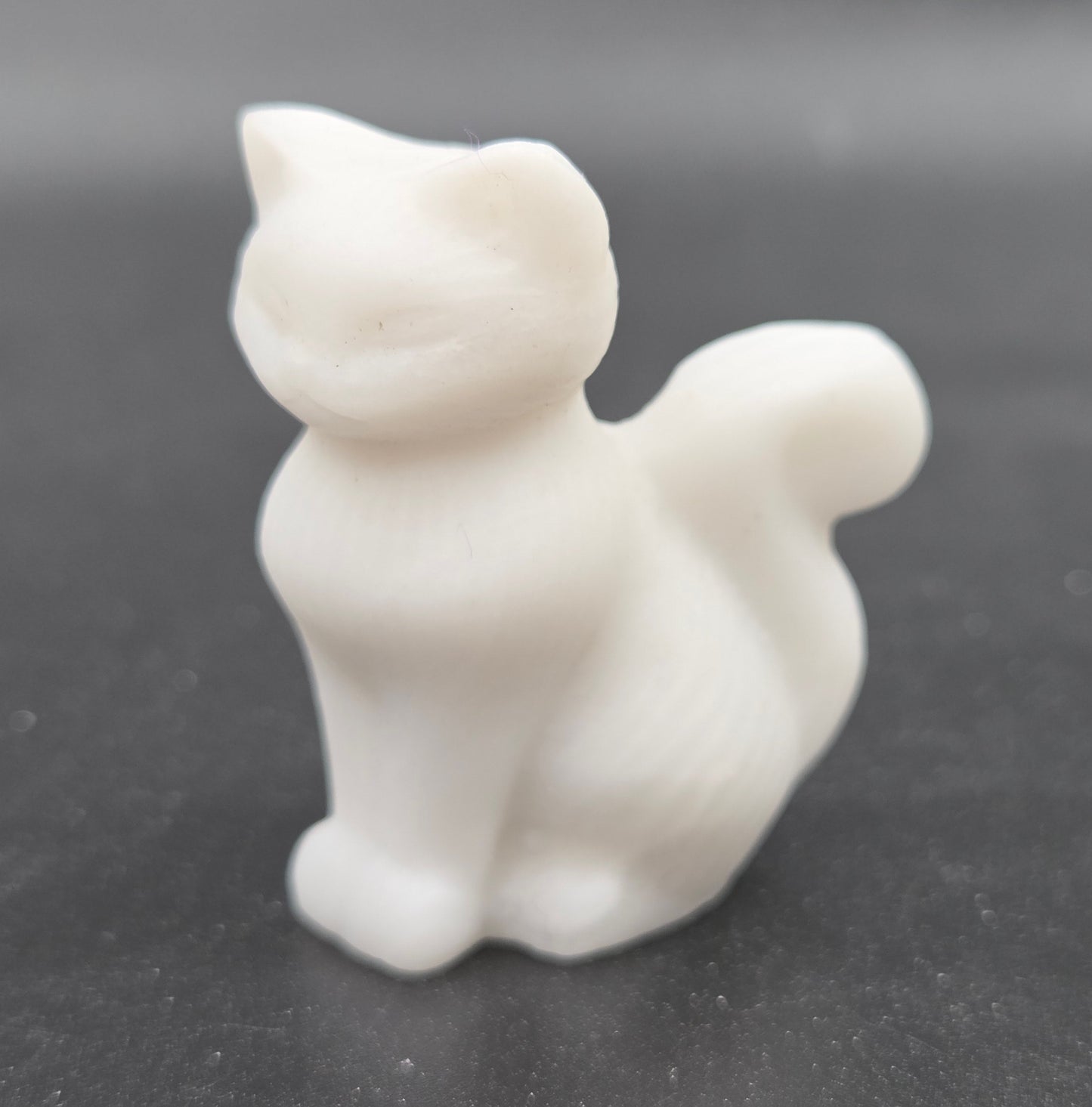 small White Jade sculpture of a cat against a neutral background
