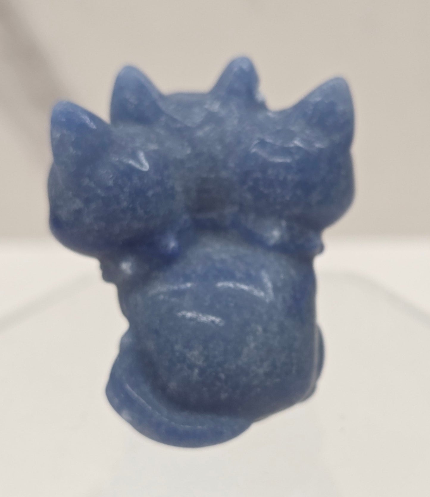 Blue Aventurine small crystal mythological cerberus animal figurines on a white surface