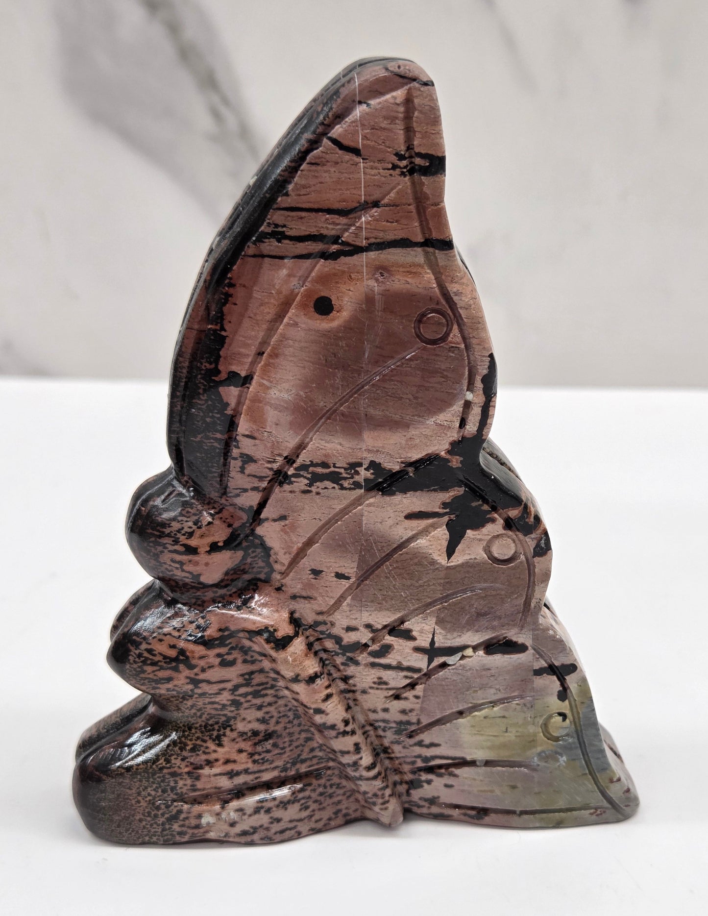 Picture Jasper fairy carving with a variety of patterns and colors on a white background