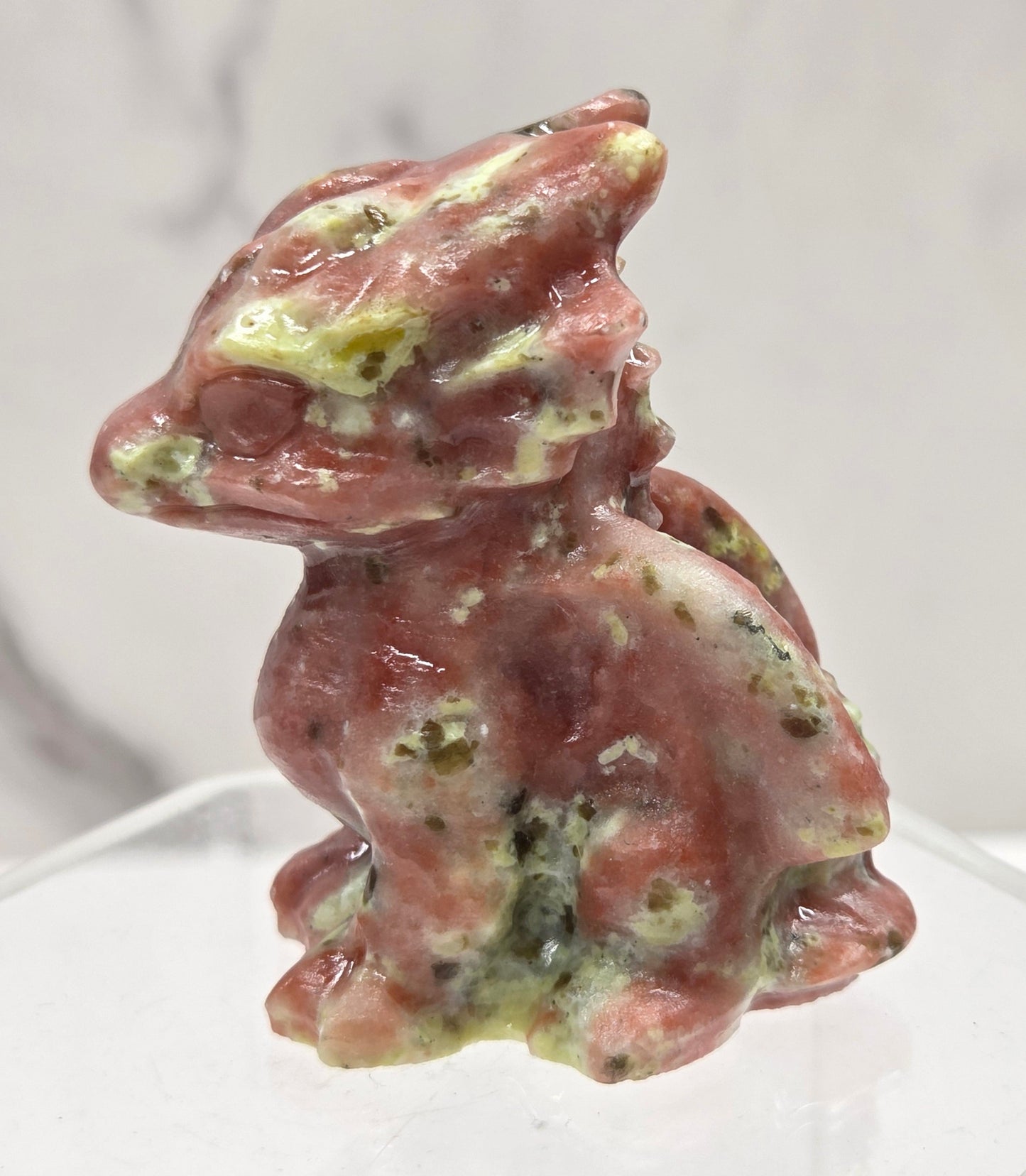Red Serpentine crystal dragon carving on a white background