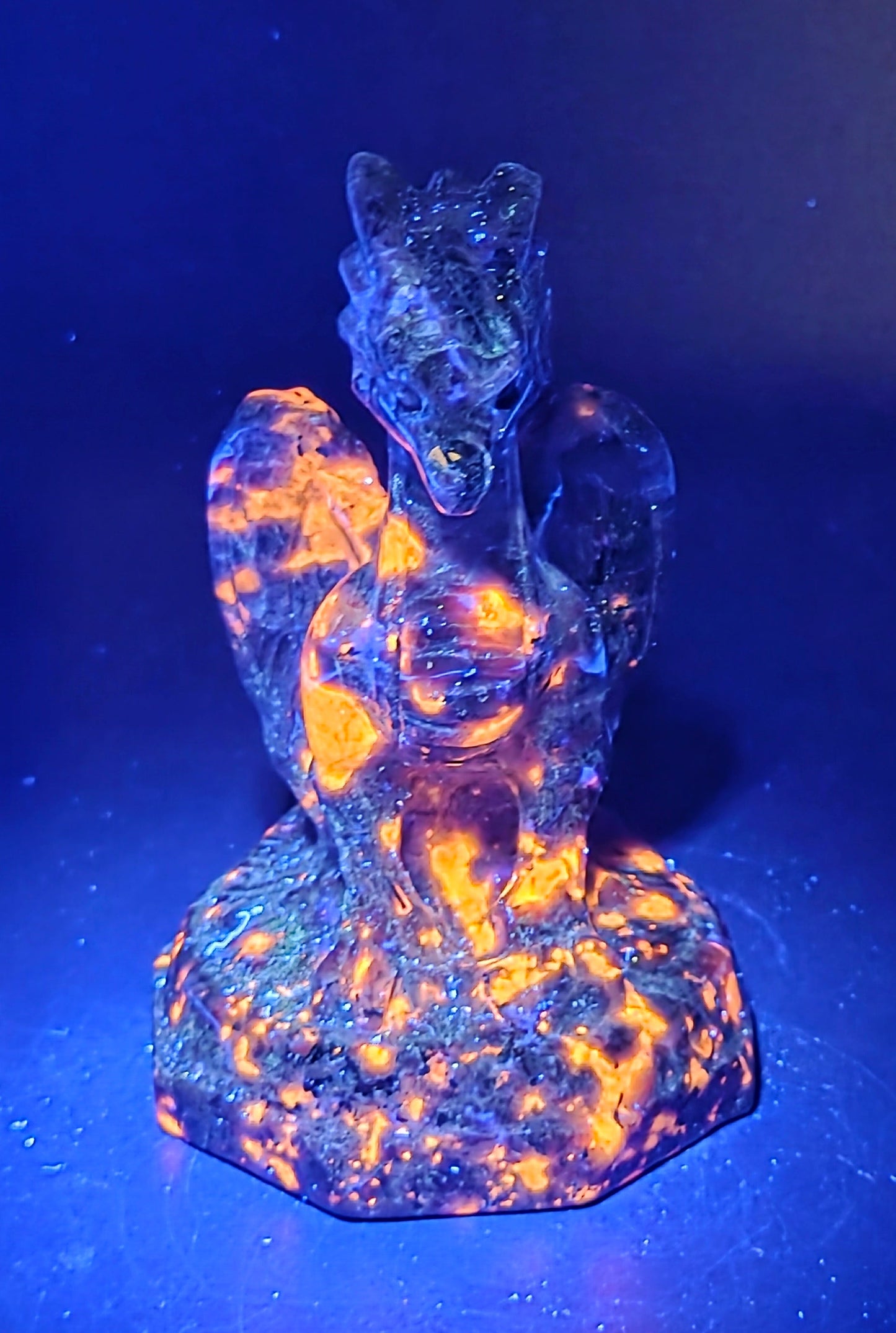 Yooperlite crystal dragon sculpture under UV light