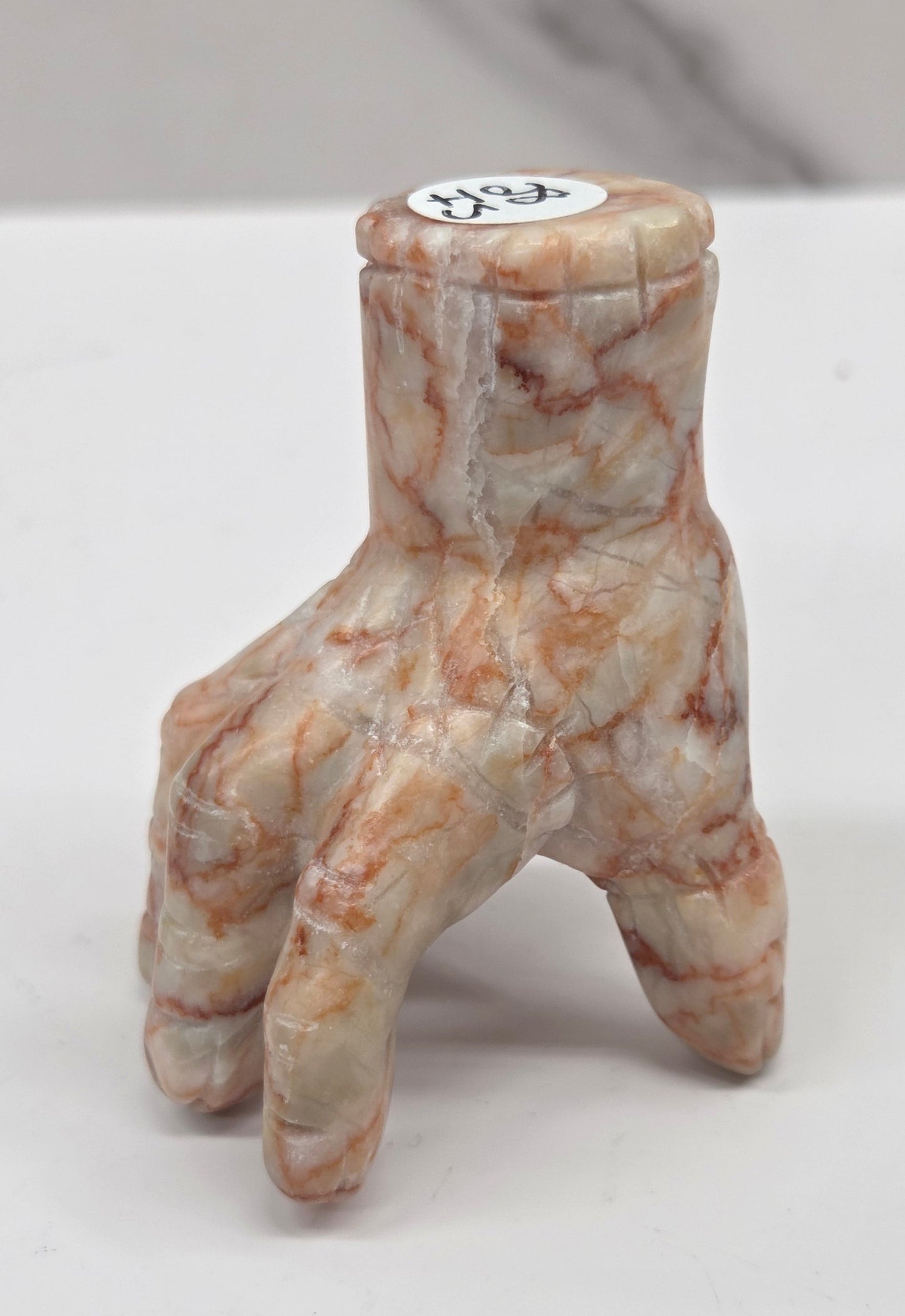 Hand carving made of Red Vein Jasper on a white background