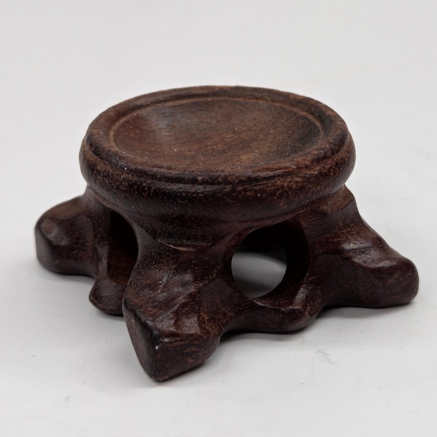 Wooden sphere stands with legs on a white background