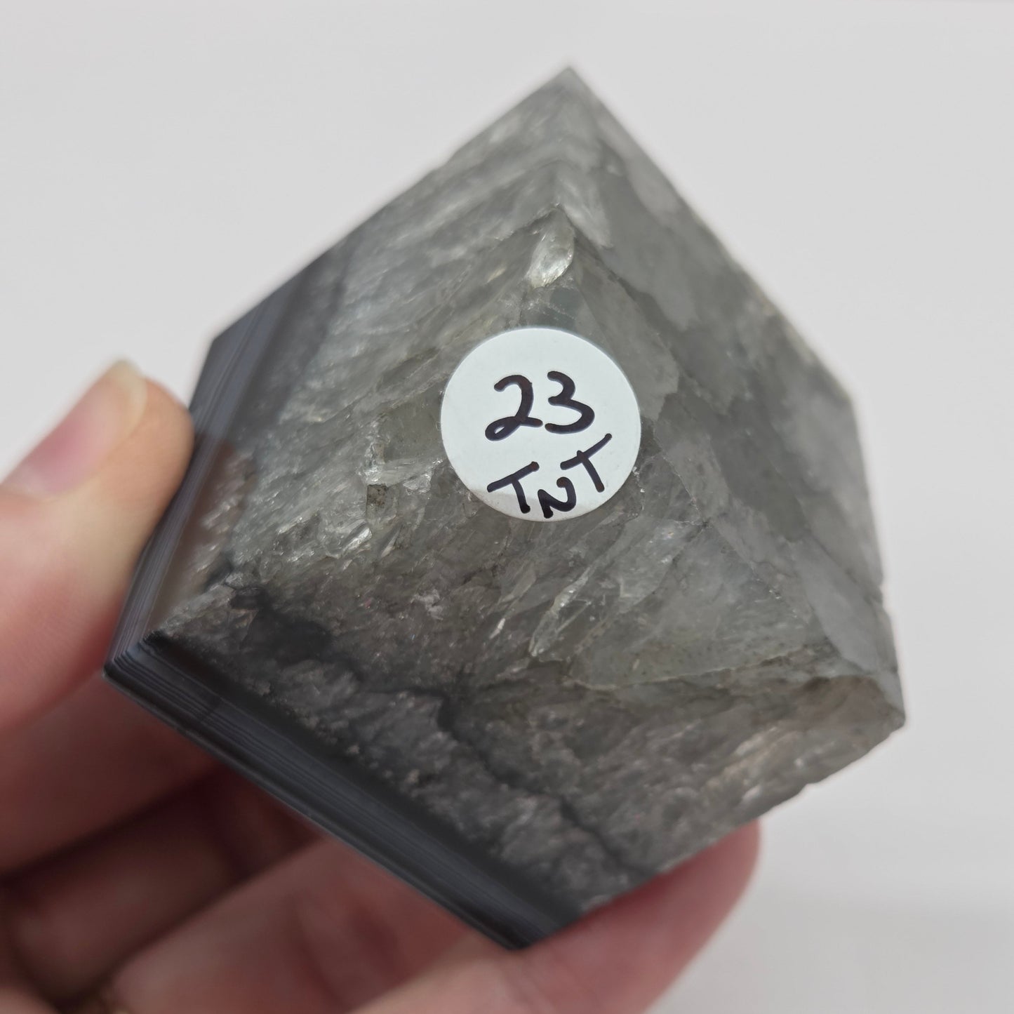 Black Agate cube shape with black and white banding and quartz on a white background