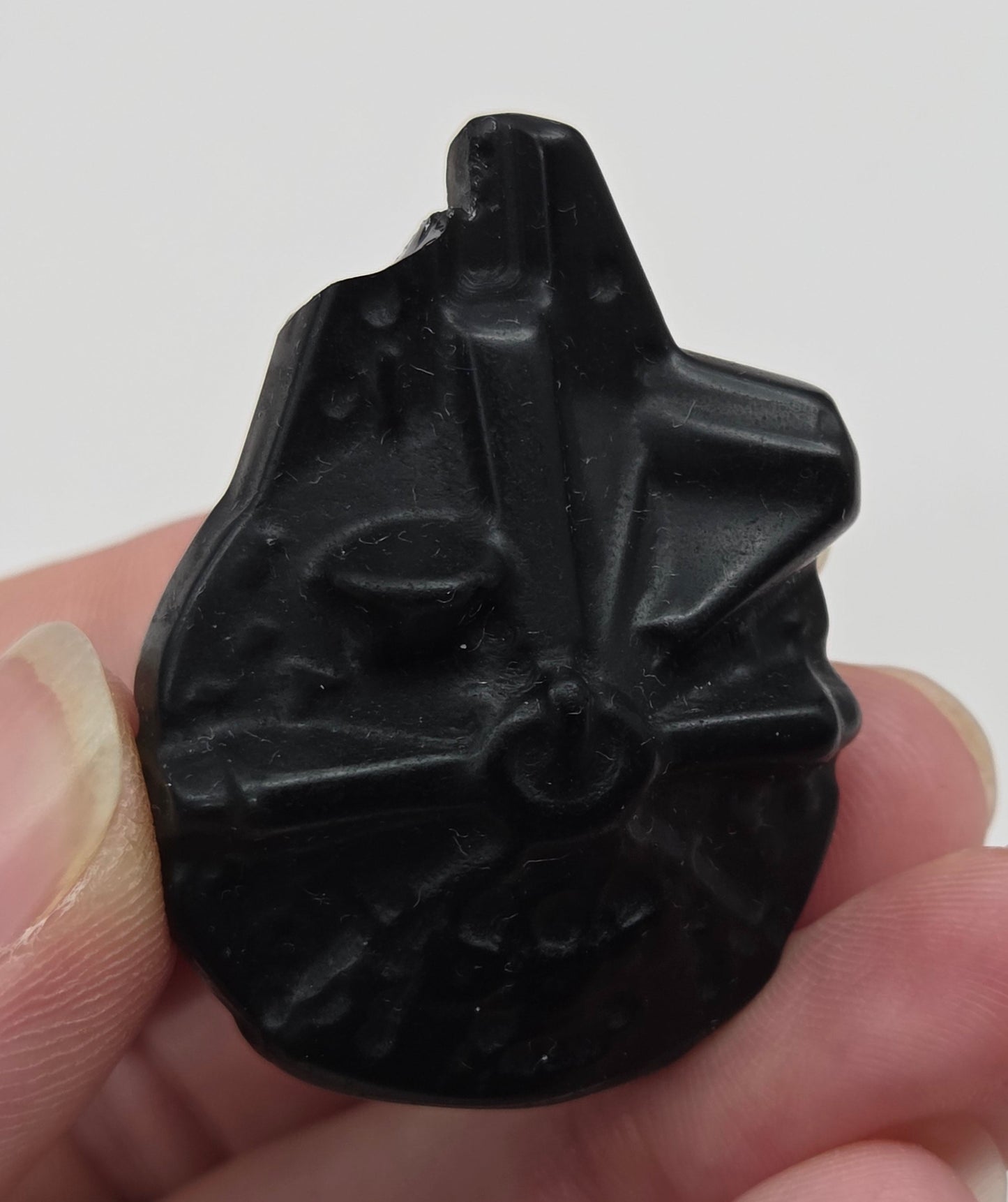 Star Wars Millennium Falcon carving made of Obsidian on a white background