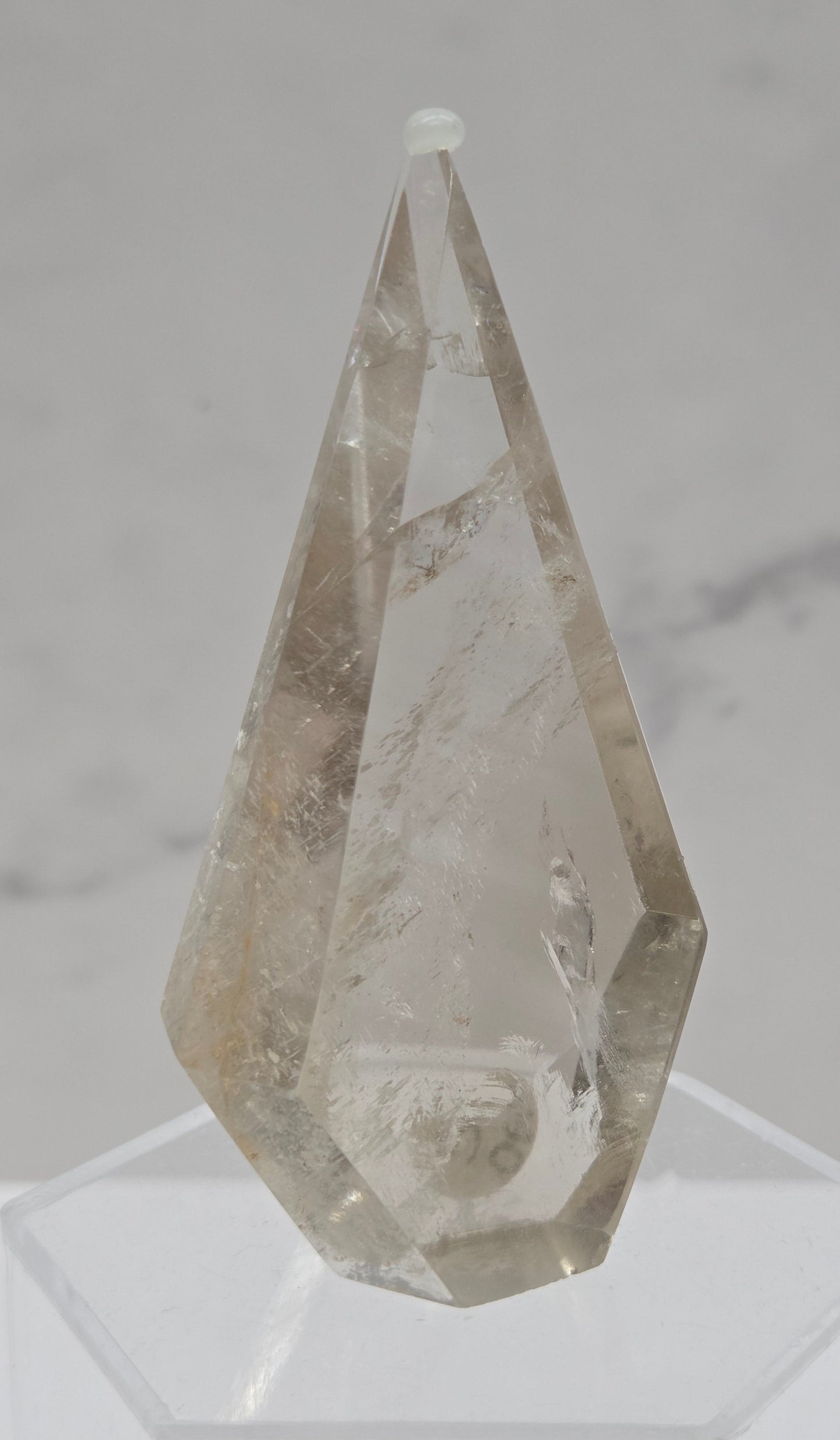 Smoky Quartz crystal object on a marble surface