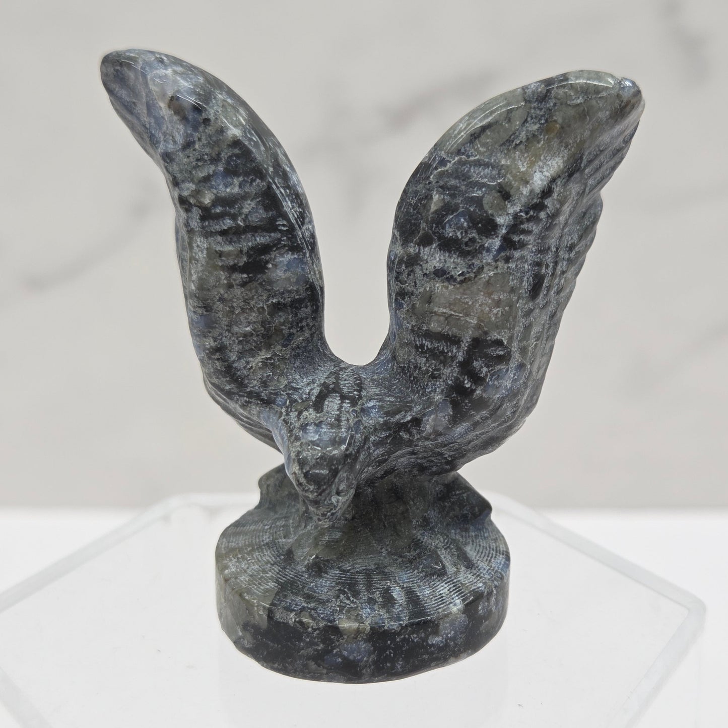 Decorative stone eagle figure on a white background