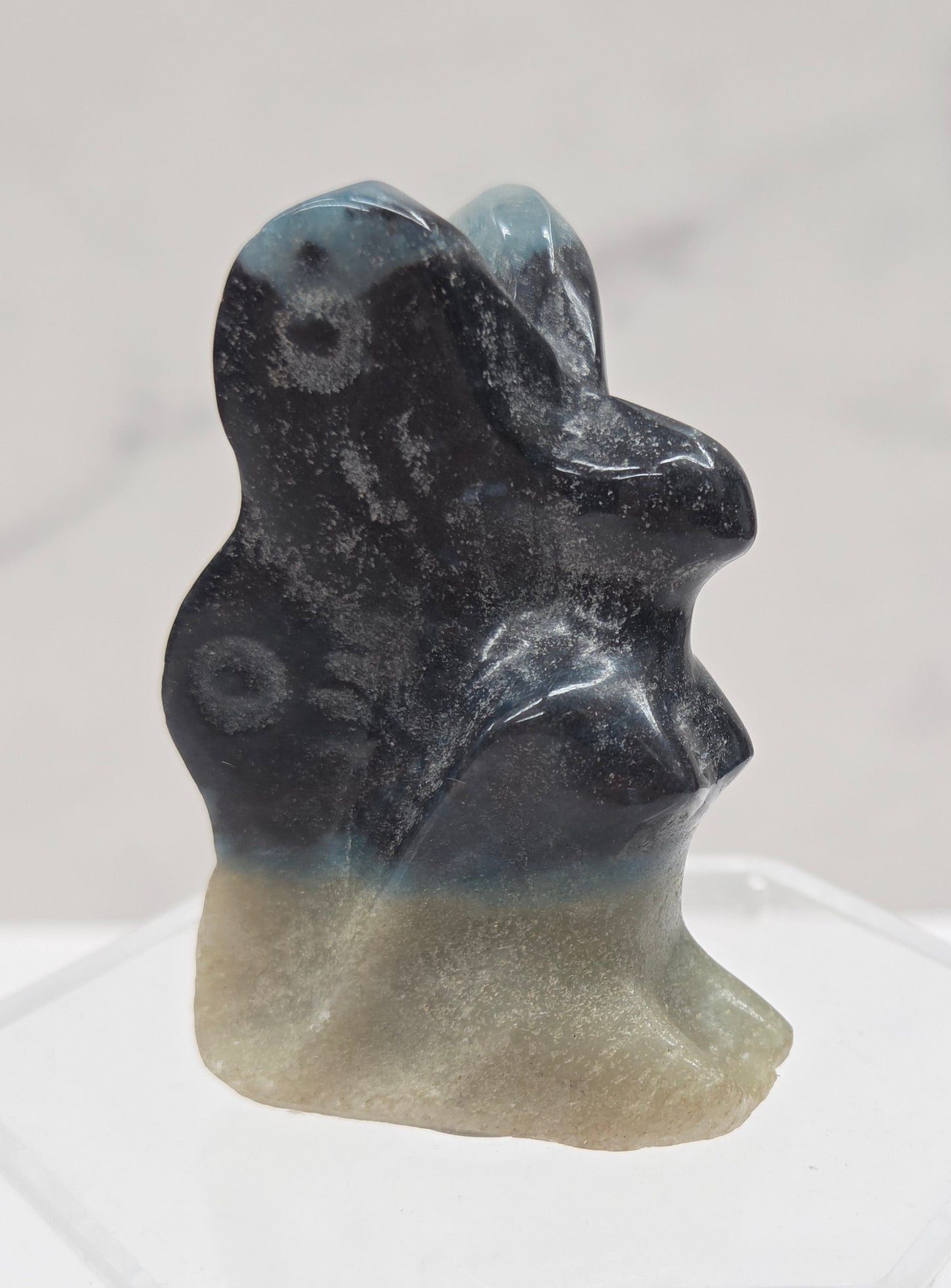 Small stone carving of a fairy on a white background