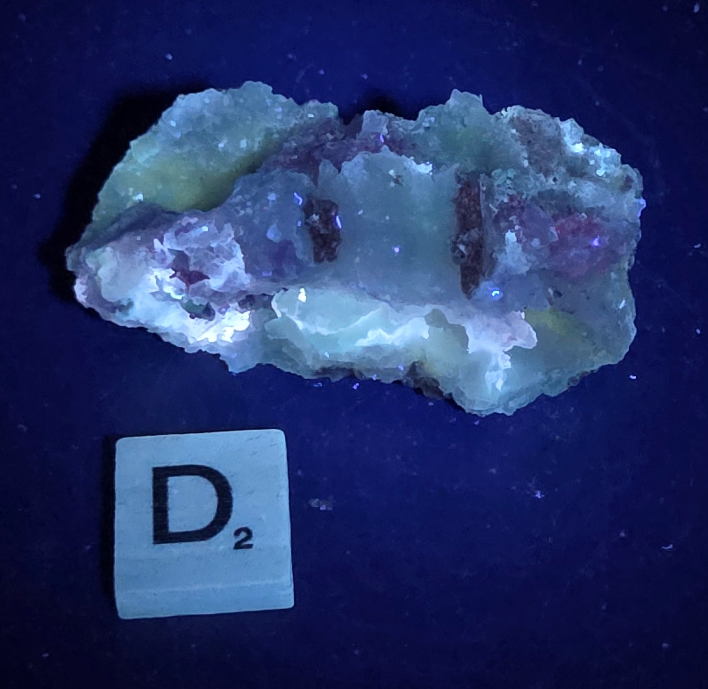 Mineral geode under UV light against a black background