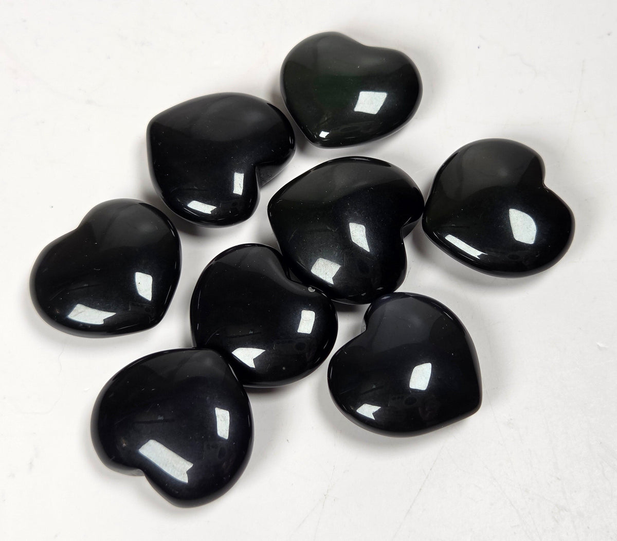 Black Obsidian heart carvings on a white background
