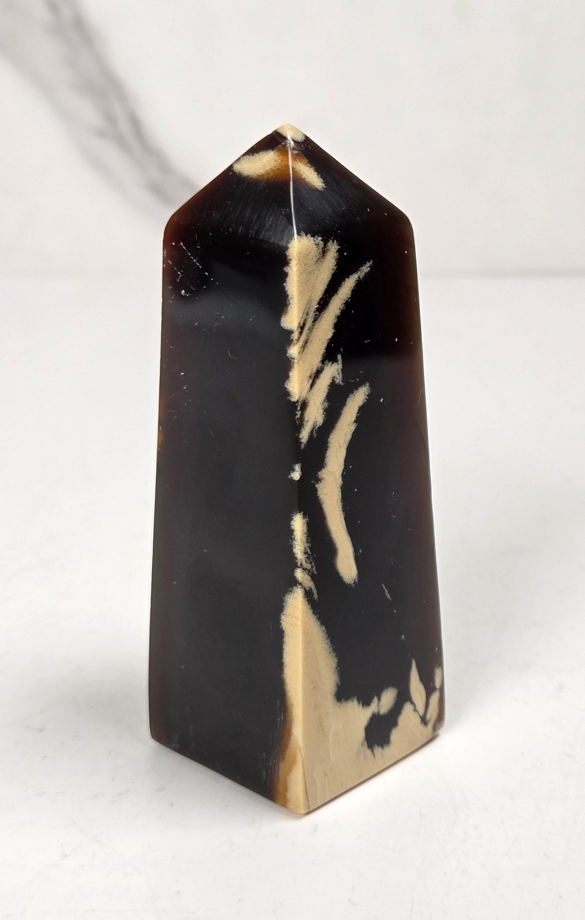 A polished amber tower displayed on a white background