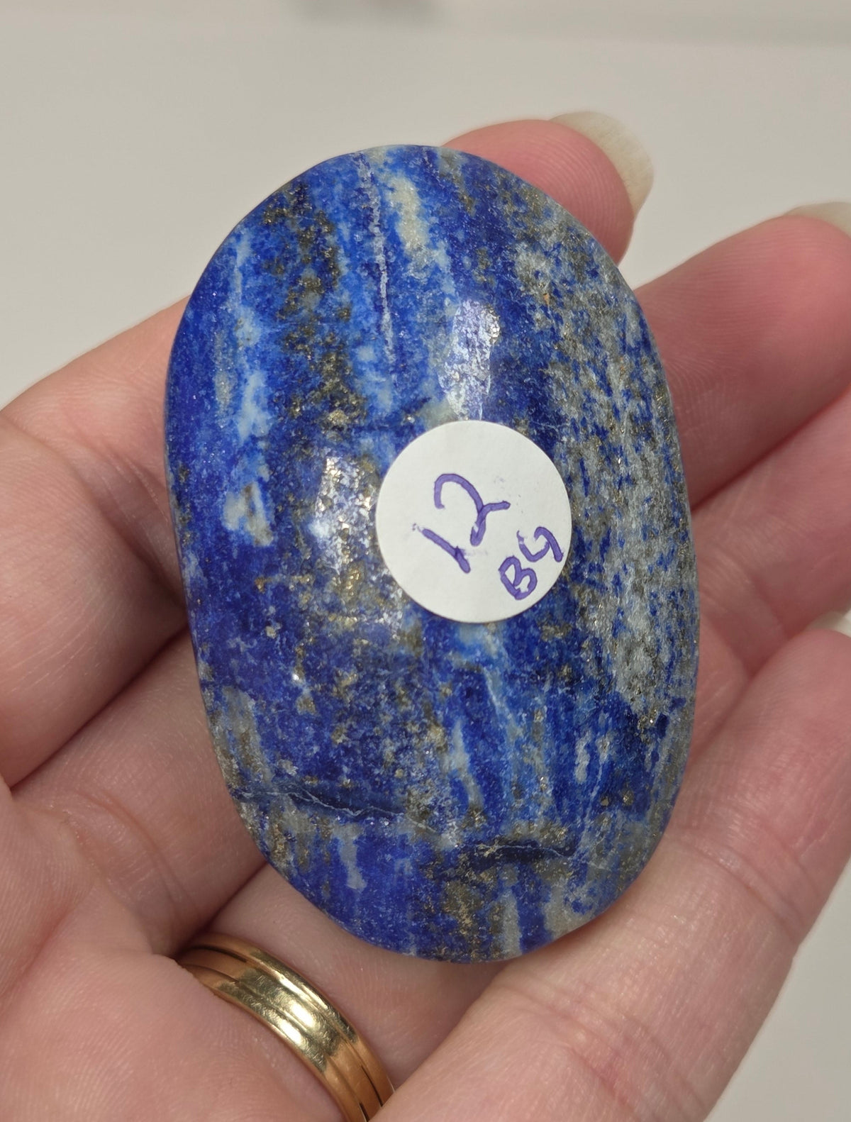 Lapis Lazuli polished palm with white, grey and blue coloring