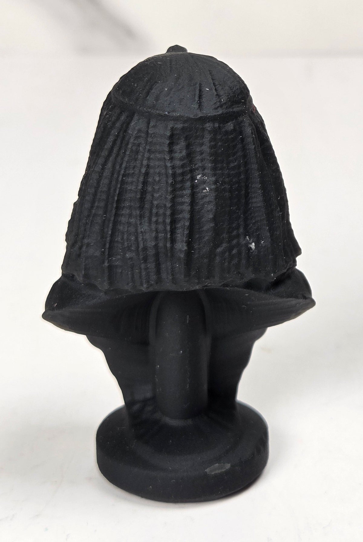 Obsidian carving of an egyptian queen against a marbled background