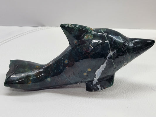 Green Ocean Jasper mineral dolphin carving with orbicular patterns in red and yellow.