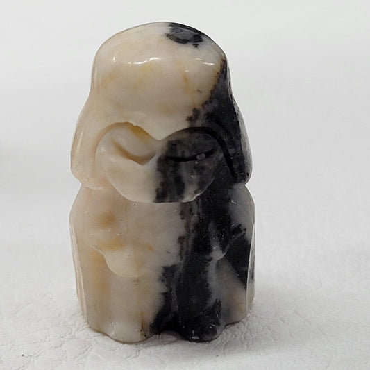 Darth Vader carving in pink zebra jasper on a white background