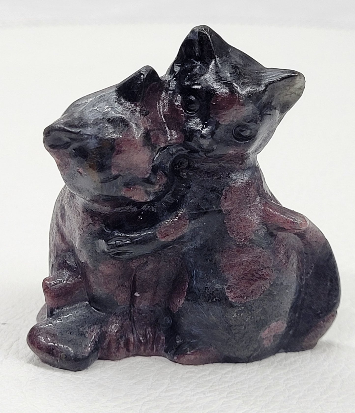 Hugging cat carvings