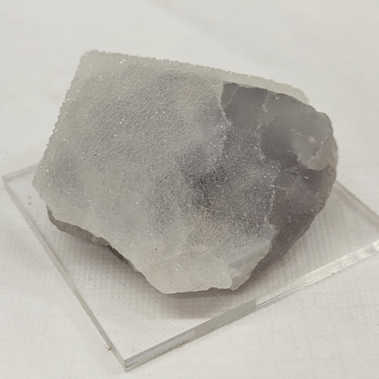 Grey colored fluorite with drusy quartz covering
