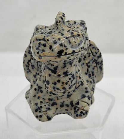 Dalmatian Jasper carving of Toothless on a white background