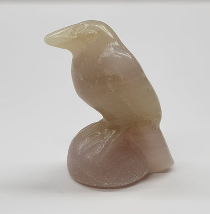 A small carving of a raven made from Pink Afghan Jade, approximately 1.5 inches tall.