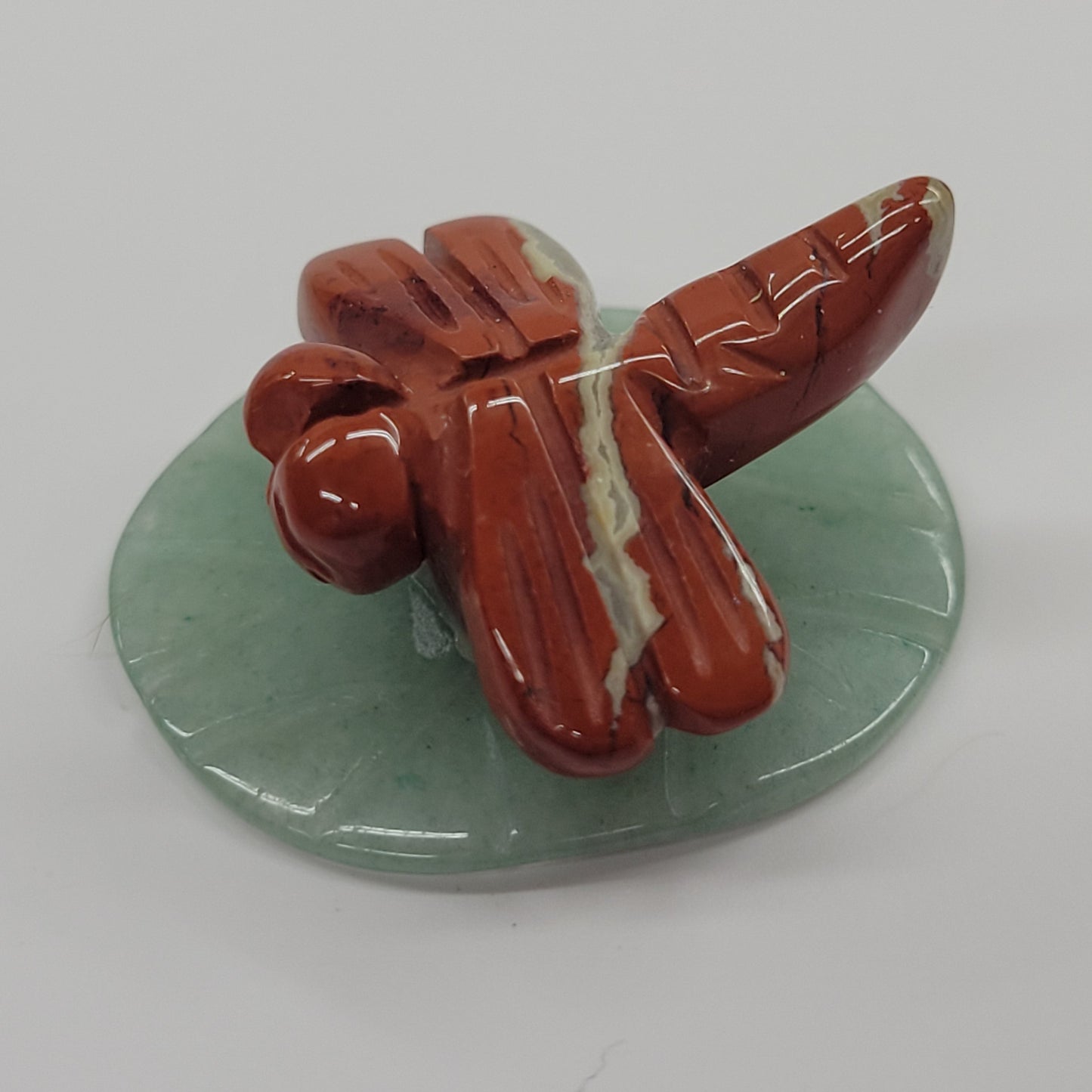 Dragonfly on lily pad carvings