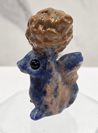 Squirrel holding nut carving