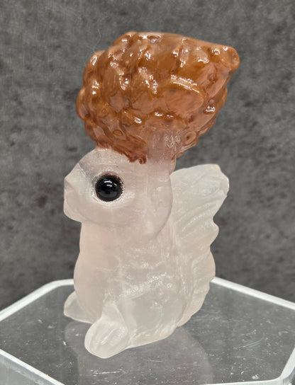 Squirrel holding nut carving