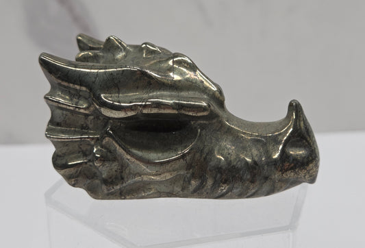 Pyrite dragon head carving on a white background