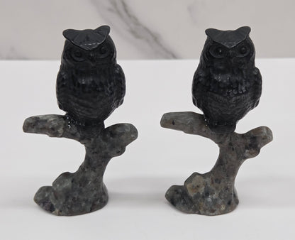 Owl sitting on branch carving