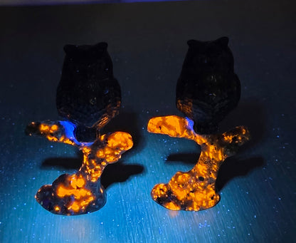 Owl sitting on branch carving