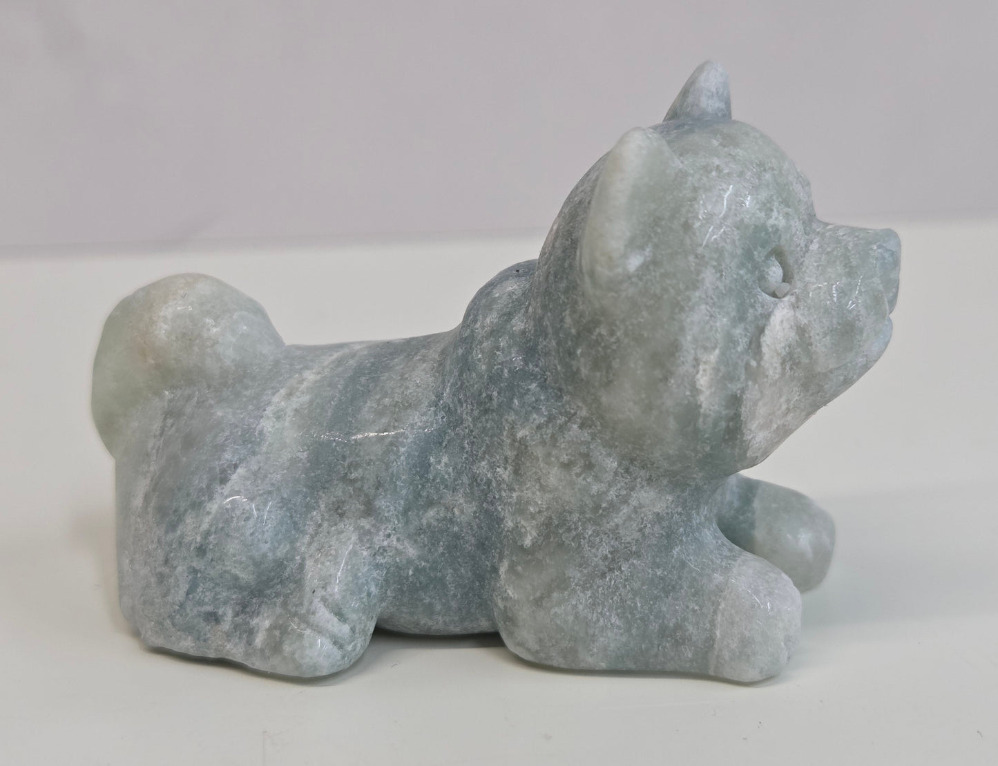 Blue Calcite dog carving on a white background