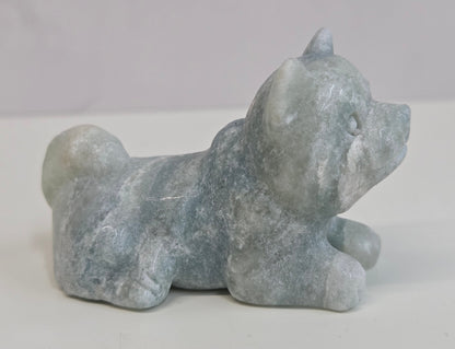 Blue Calcite dog carving on a white background