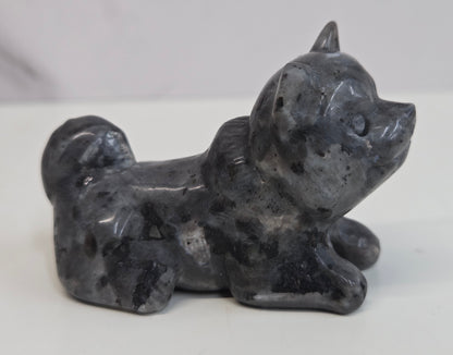 Larvikite dog carving on a white background